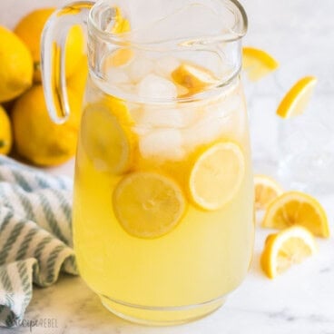 square image of glass pitcher with homemade lemonade and lemon slices.