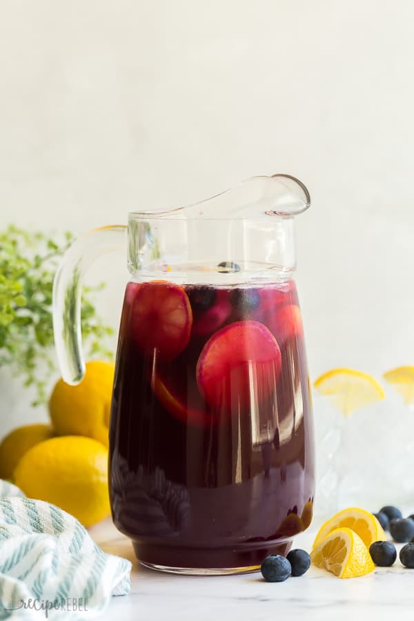 blueberry lemonade with lemon slices and blueberries in glass pitcher