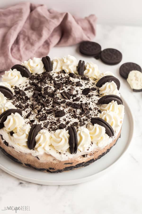 oreo ice cream cake whole with whipped cream and halved oreos