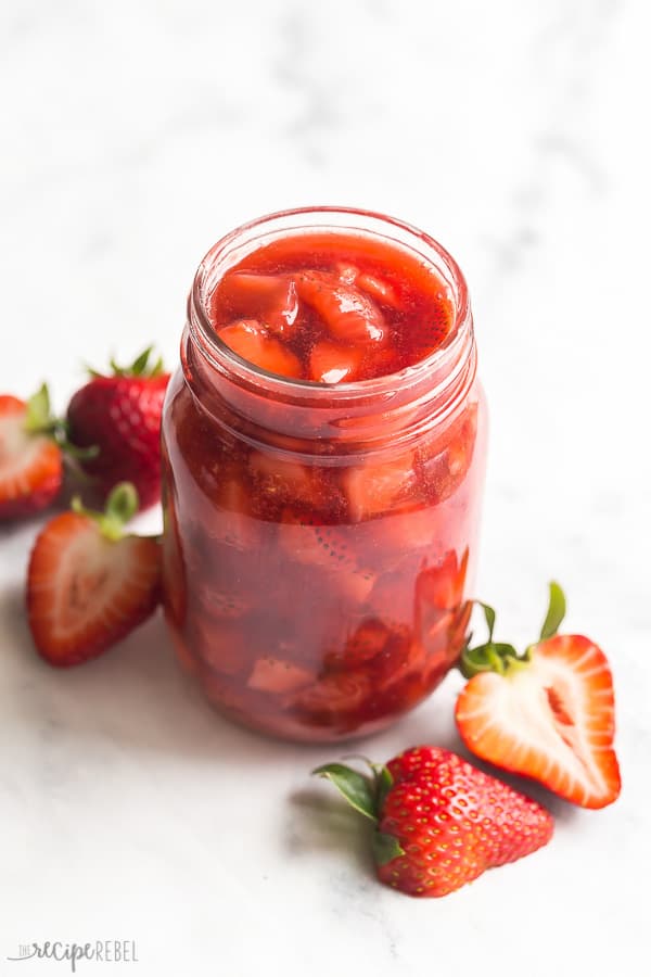strawberry sauce in glass jar with fresh strawberries