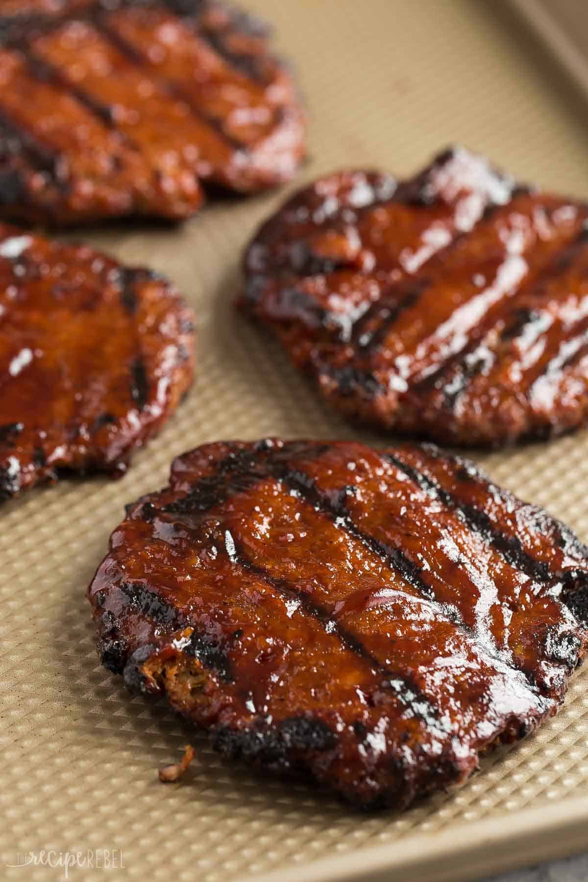 These Grilled Turkey Burgers are an easy summer meal that is make ahead and freezer friendly! The perfect healthy meal prep dinner for summer, and loaded with flavor from red onion and barbecue sauce! #dinner #recipe #burger | grilling recipes | summer food | summer dinner | burger recipes | turkey burger recipe | ground turkey | healthy burgers grilled turkey burgers on a baking sheet.