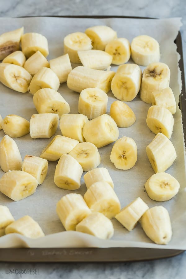 banana chunks on parchment lined baking sheet ready to freeze