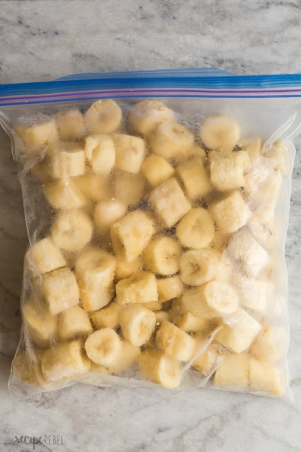 frozen banana chunks in large freezer bag on grey marble background