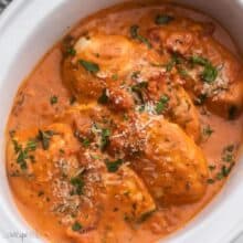square image of tomato basil slow cooker chicken in white crockpot.
