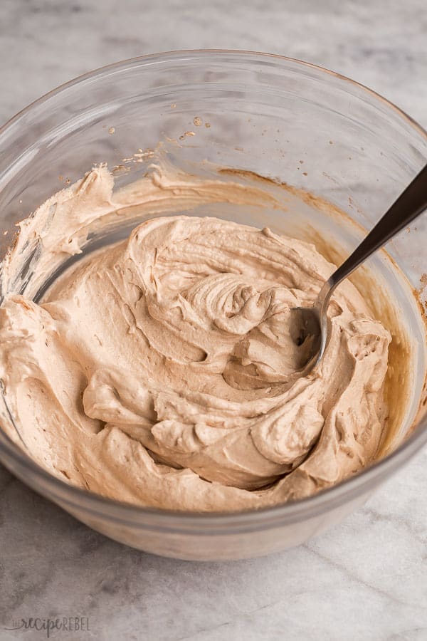 chocolate peanut butter whipped cream recipe in glass bowl on grey marble background