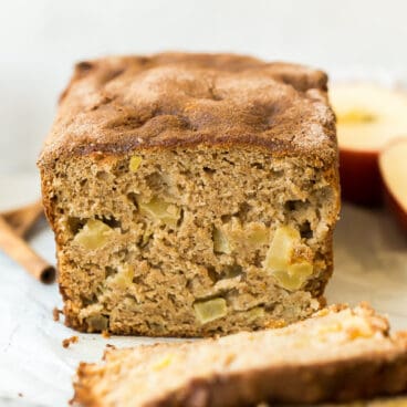 apple bread on marble background with two slices cut