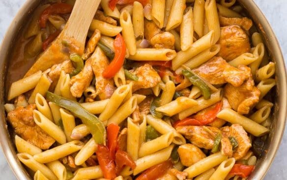 overhead image of chicken fajita pasta in stainless steel skillet