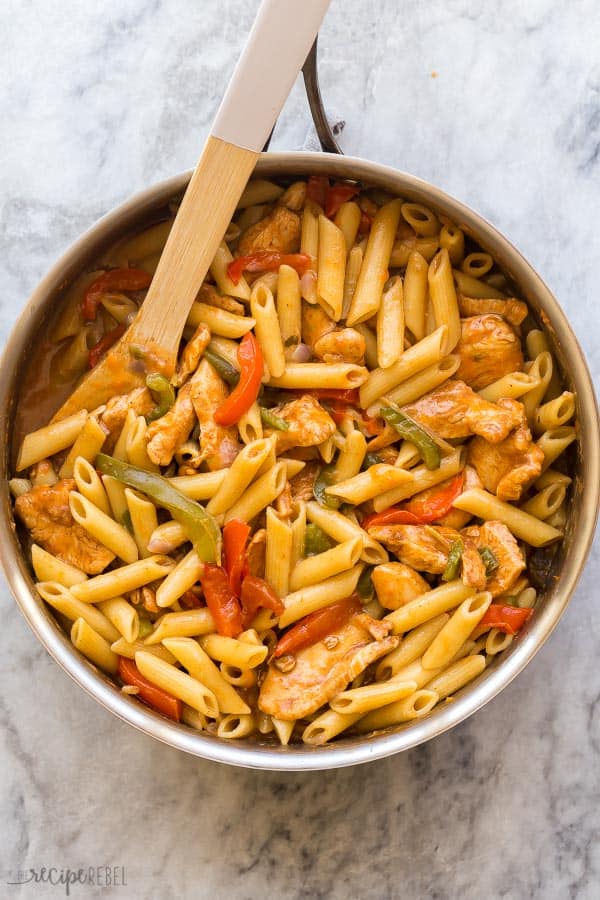 This One Pot Chicken Fajita Pasta is a complete meal in one, with veggies, sliced chicken breasts, and pasta in one flavorful sauce! #pasta #onepot #dinner #chicken #recipe overhead image of chicken fajita pasta in stainless steel skillet