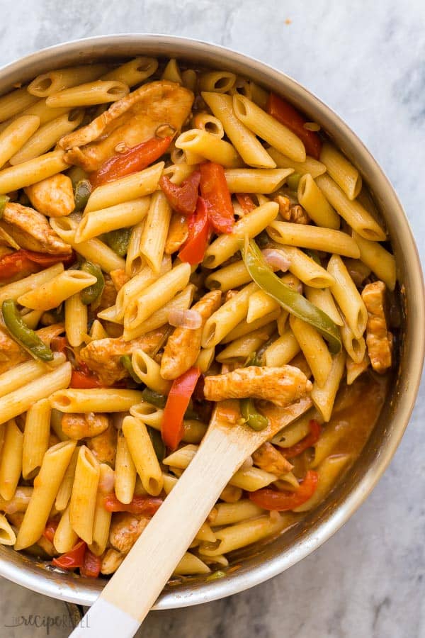 close up image of chicken fajita pasta in steel skillet