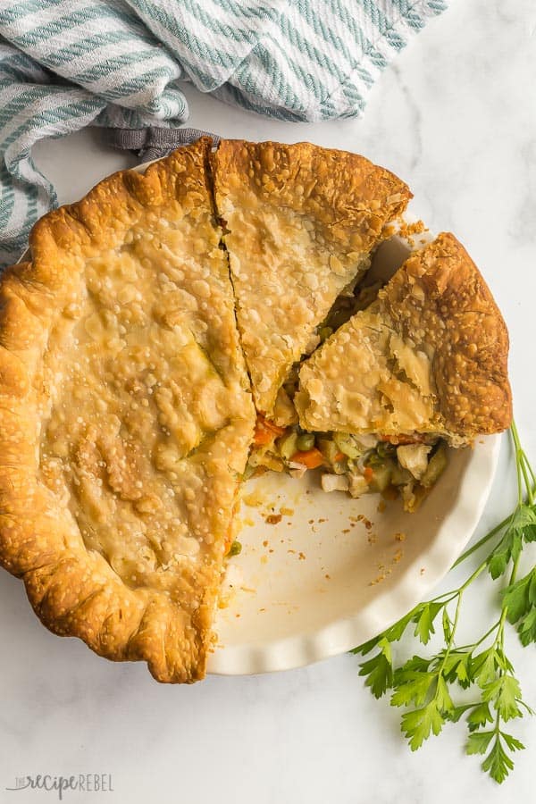 overhead image of chicken pot pie in baking dish with piece missing