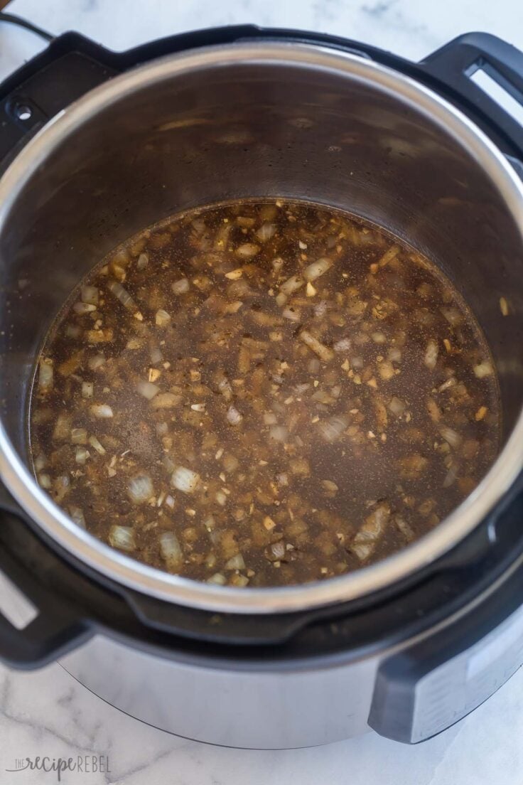 deglazing the instant pot with beef broth to make gravy