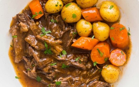 square image of instant pot pot roast with potatoes and carrots on the side