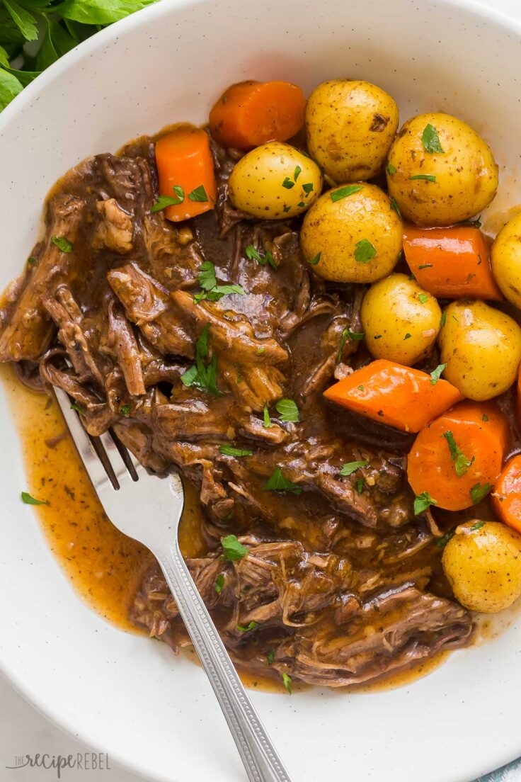 close up image of pressure cooker pot roast in bowl with fork