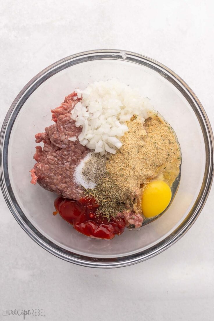 ingredients for meatloaf in a glass bowl.