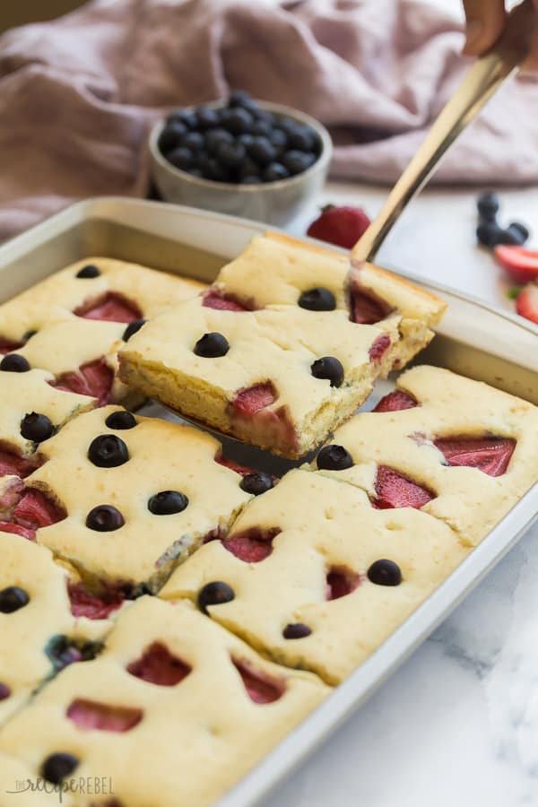 sheet pan pancakes cut and one piece being scooped out