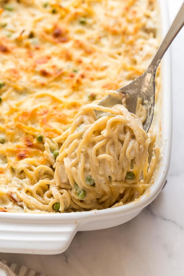 close up image of noodles being scooped on metal spoon