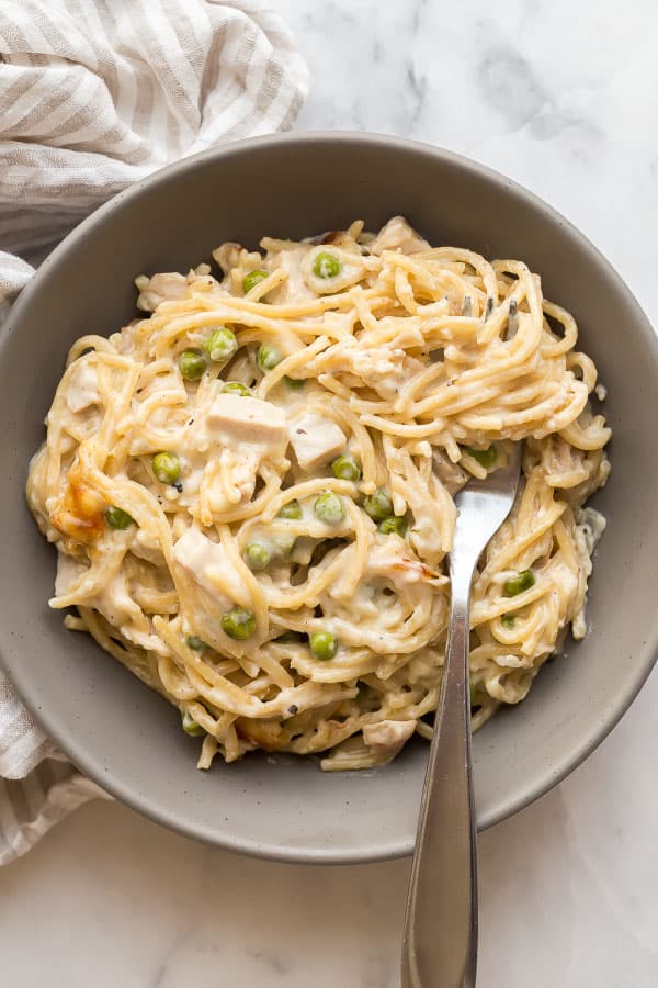 turkey tetrazzini in bowl with fork stuck in noodles