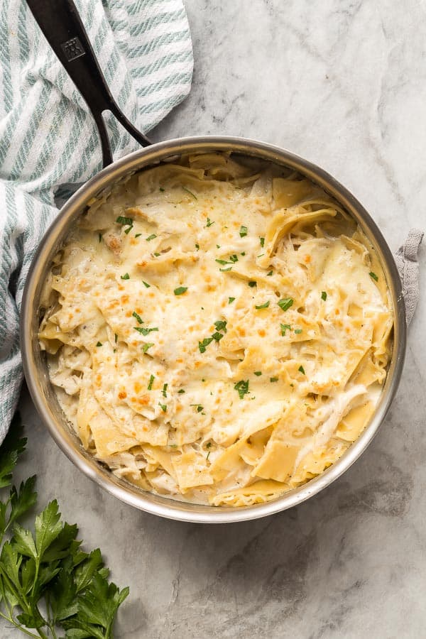 overhead image of white chicken lasagna in stainless steel pan