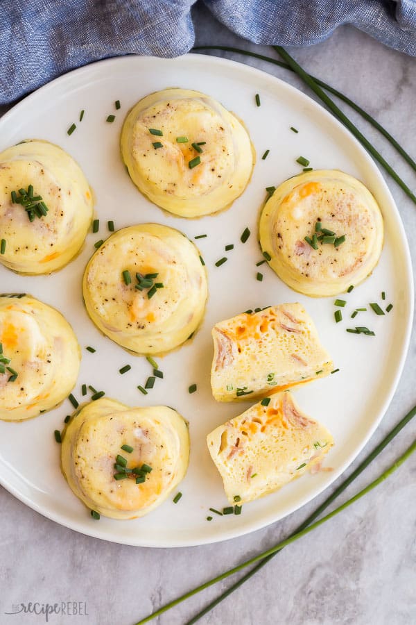 overhead image of egg bites on white plate on grey marble background