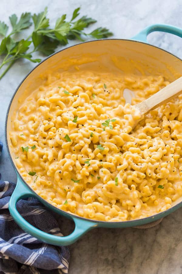 skillet macaroni and cheese with wooden spoon in pan