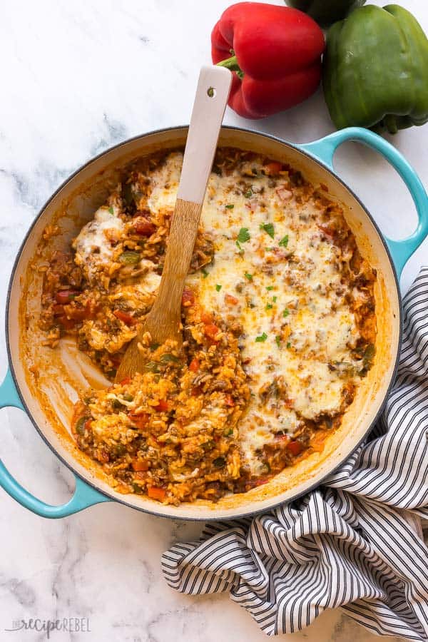 overhead image of stuffed pepper casserole with wooden spoon stuck in