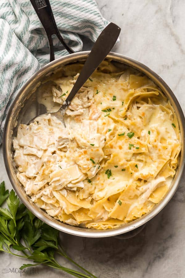 white chicken skillet in steel pan with spoon scooping some noodles