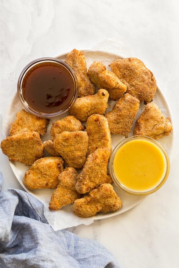 overhead image of air fryer turkey nuggets on white plate with dipping sauce
