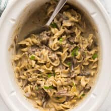 overhead image of crockpot beef and noodles in slow cooker