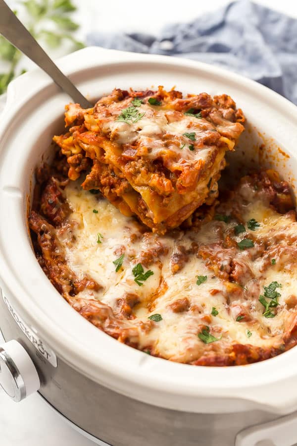 slice of lasagna being lifted out of crockpot