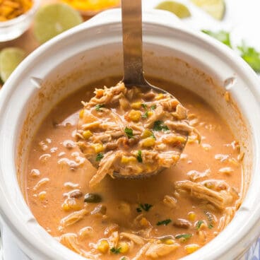 creamy chicken taco soup being scooped out of slow cooker