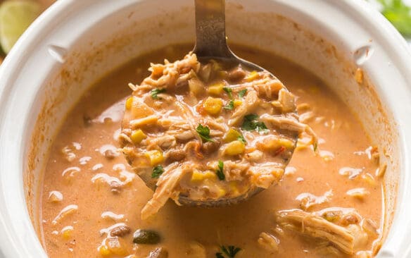 creamy chicken taco soup being scooped out of slow cooker