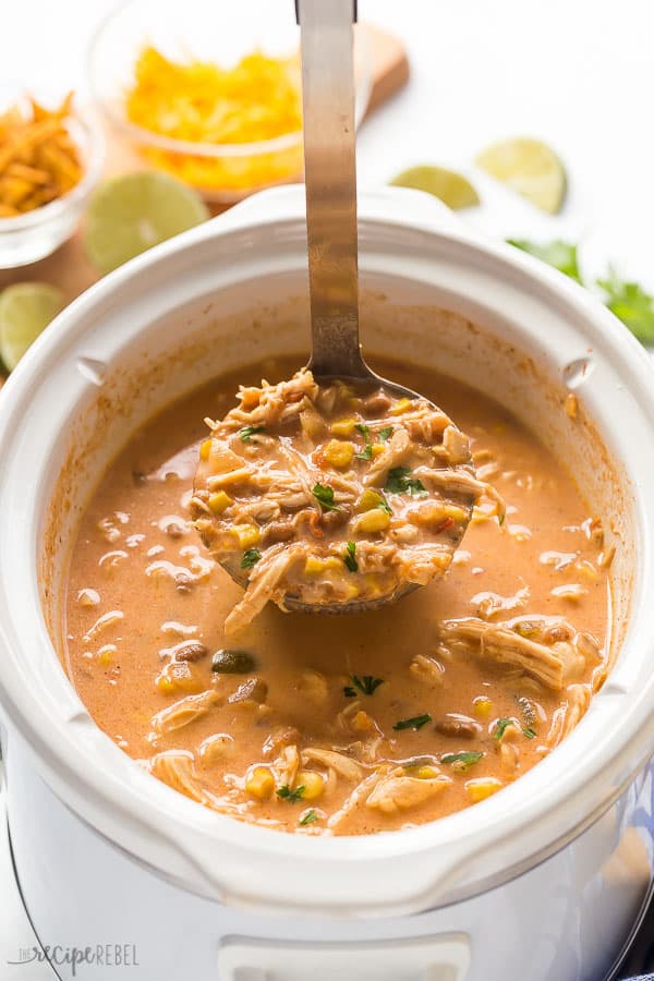 creamy chicken taco soup being scooped out of slow cooker