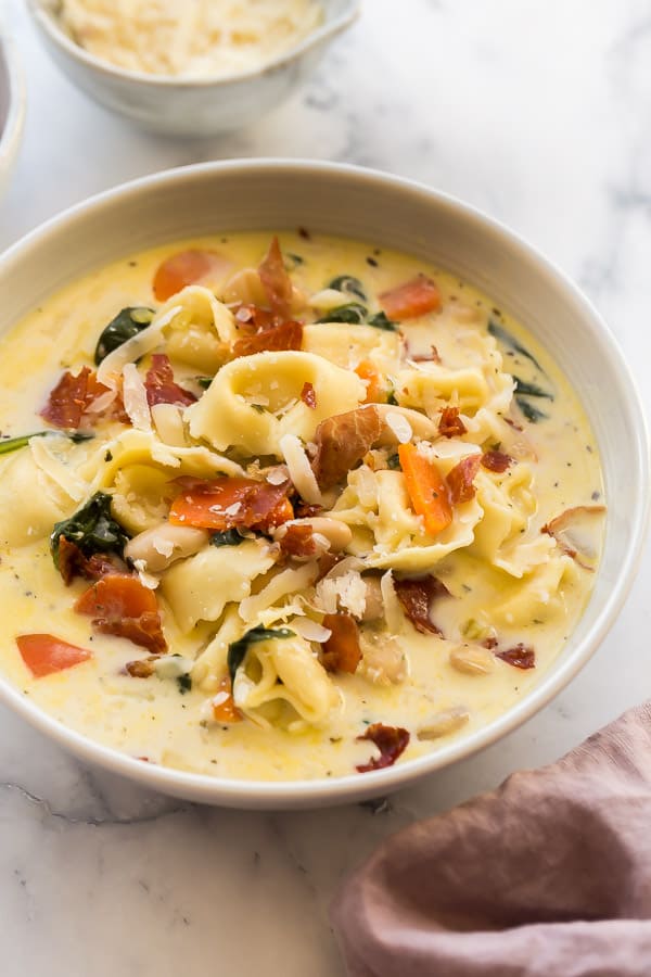 close up image of spinach tortellini soup in bowl