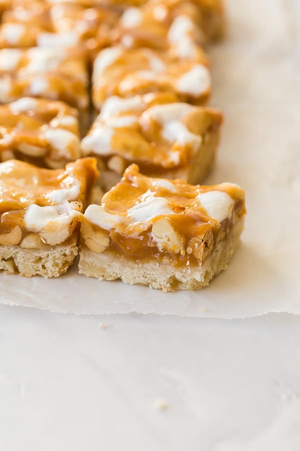 caramel nut bars lined up on wax paper