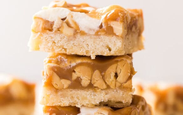 stack of three caramel nut bars on white background