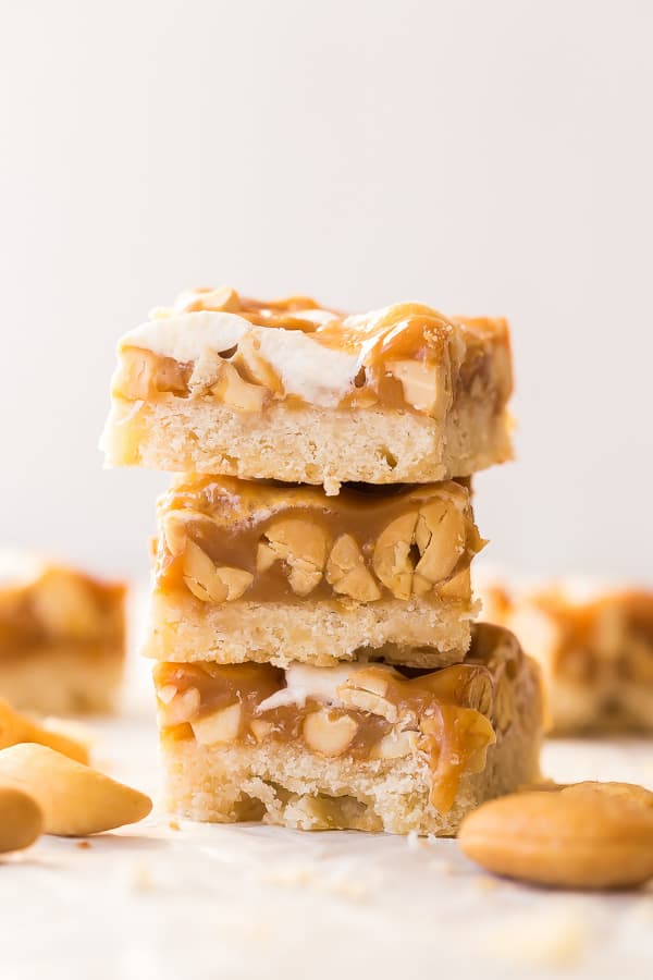 stack of three caramel nut bars on white background