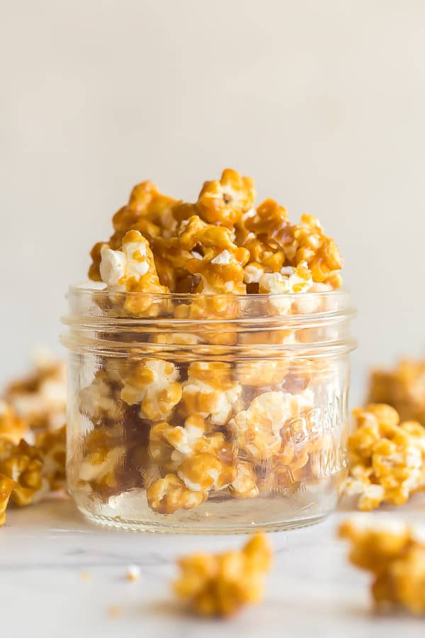 close up image of caramel popcorn in glass jar