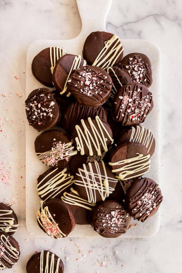 overhead image of stacks of chocolate slice and bake cookies on marble board