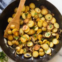 overhead image of lyonnaise potatoes in black skillet