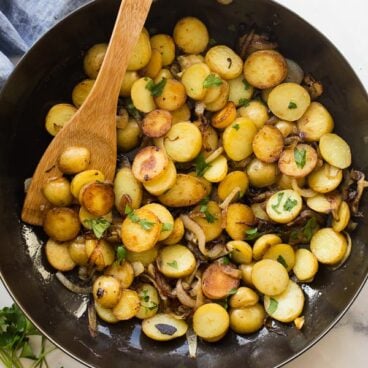 overhead image of lyonnaise potatoes in black skillet