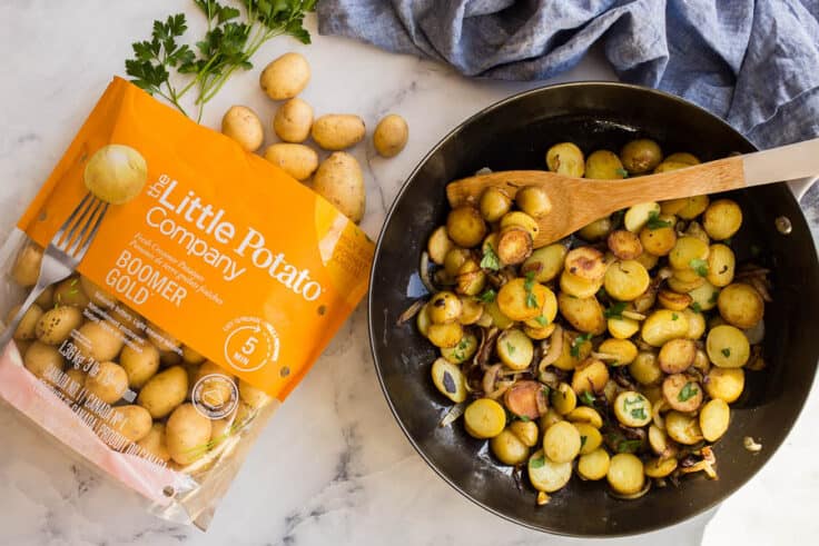 overhead image of potatoes in skillet beside a bag of little potatoes
