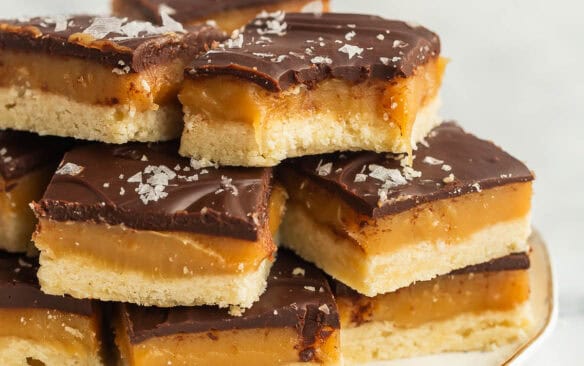 square image of stack of chocolate caramel shortbread.