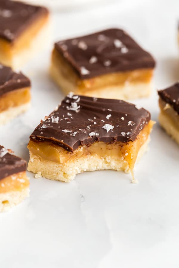close up image of one piece of millionaire shortbread with bite taken
