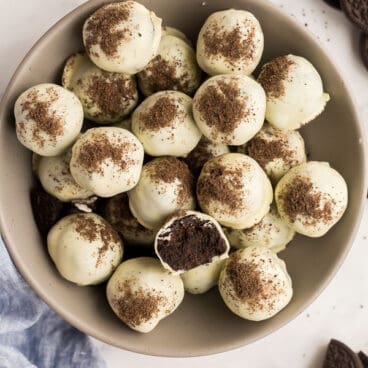 overhead image of oreo balls in grey bowl with one cut open