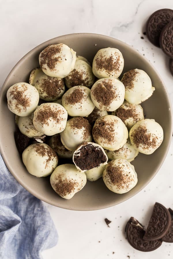 overhead image of oreo balls in grey bowl with one cut open