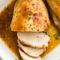 Overhead image of roast turkey breast in white baking dish