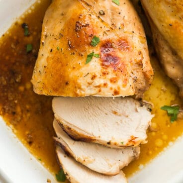 Overhead image of roast turkey breast in white baking dish