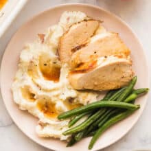 plate of turkey breasts with mashed potatoes and green beans