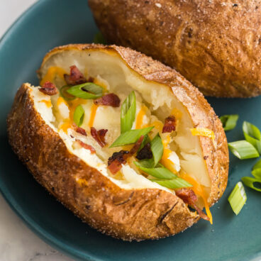 square image of air fryer baked potato with toppings.