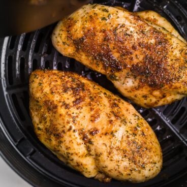 square image of air fryer chicken breast in basket.